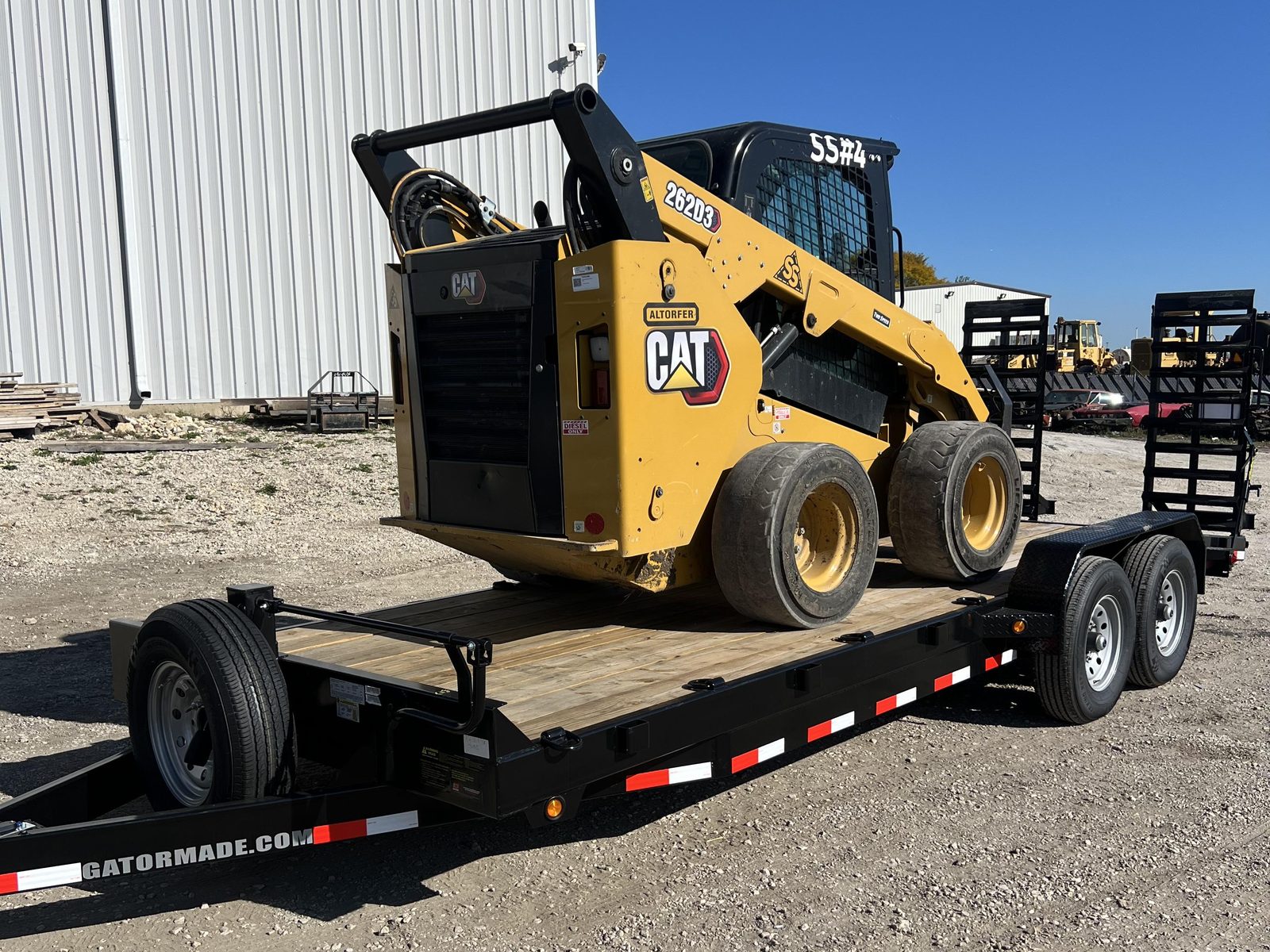 Hooked Up Trailers CAT skid steer loaded on an equipment trailer in Elgin, IL